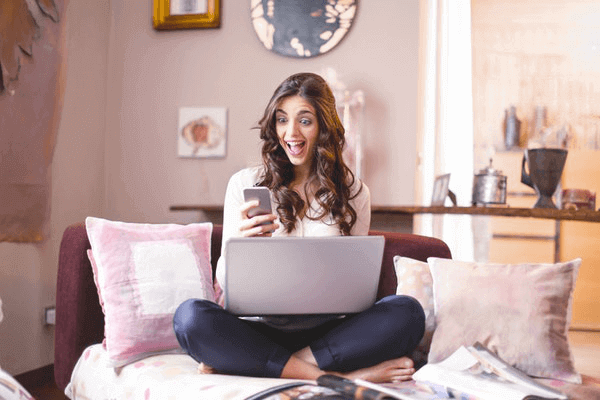 15 Ways to Celebrate a Long Distance Relationship Anniversary - surprised girl on laptop